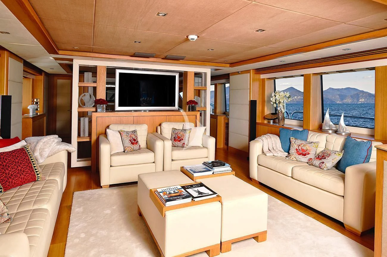 a living room with a couch and a tv aboard TENACITY Yacht for Sale