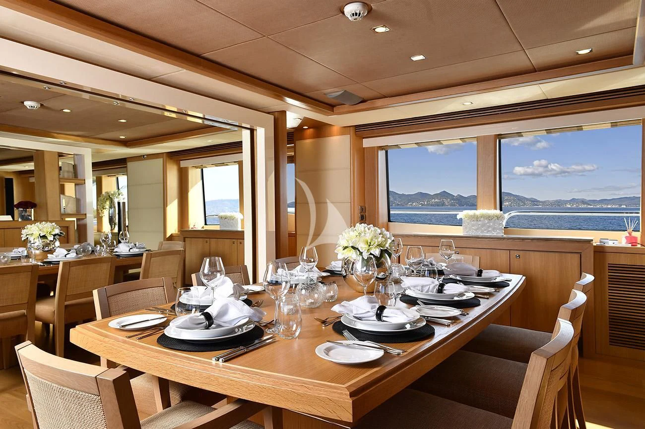 a dining room with a large window aboard TENACITY Yacht for Sale