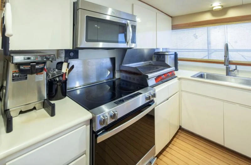 a kitchen with a stove and a sink aboard GOLDEN EAGLE Yacht for Sale