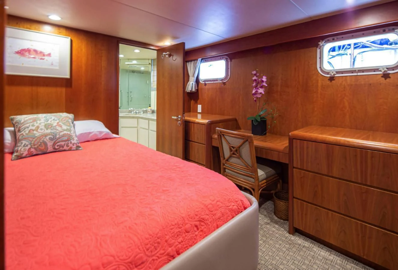 a bedroom with a bed and a chair aboard GOLDEN EAGLE Yacht for Sale