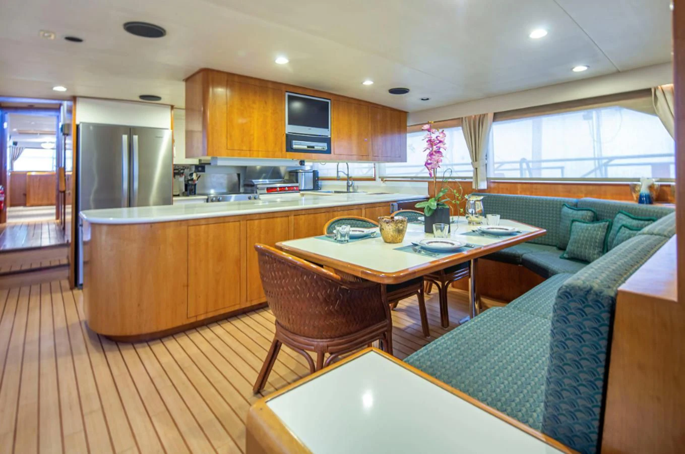 a kitchen with a table and a couch aboard GOLDEN EAGLE Yacht for Sale