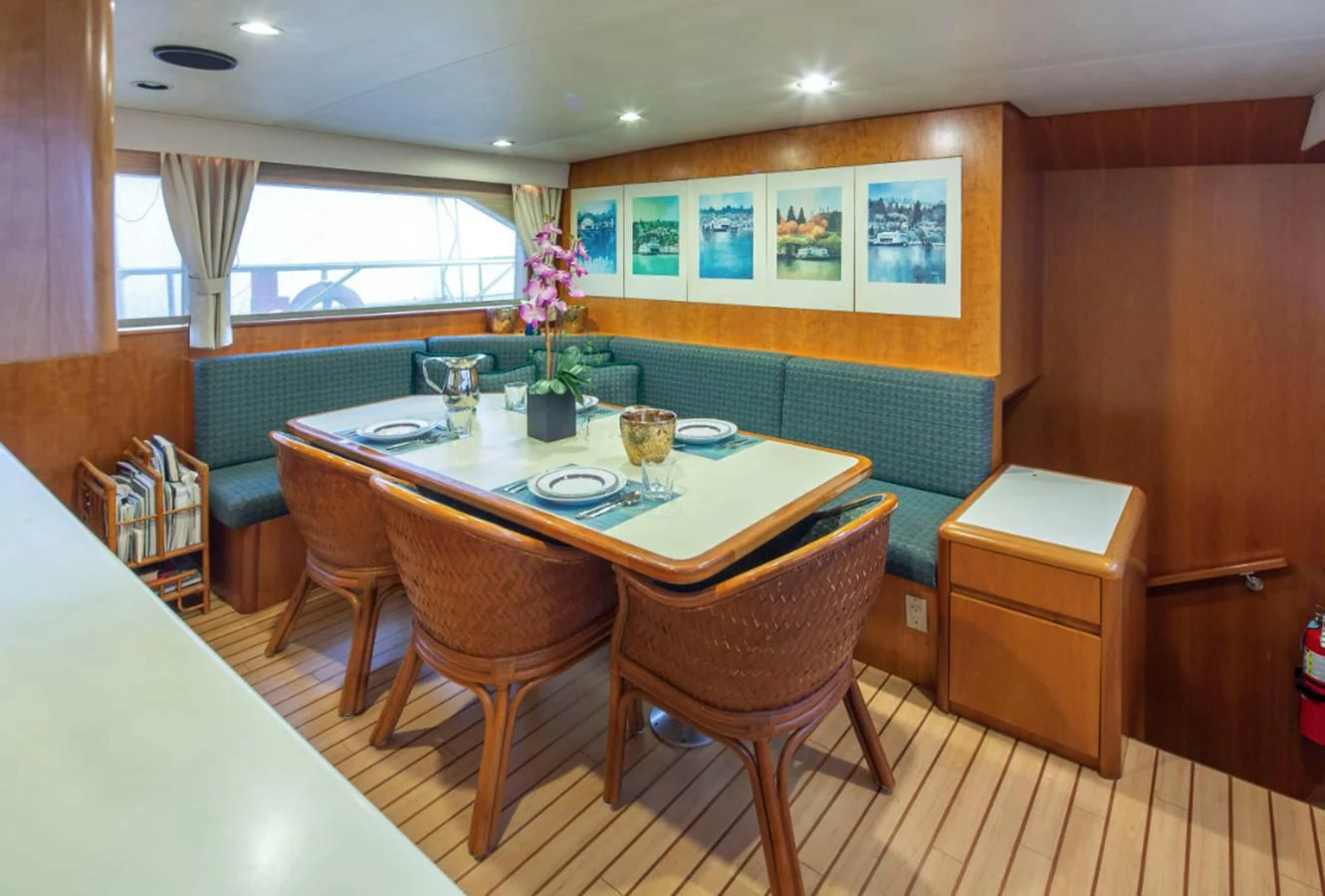 a room with a table and chairs aboard GOLDEN EAGLE Yacht for Sale