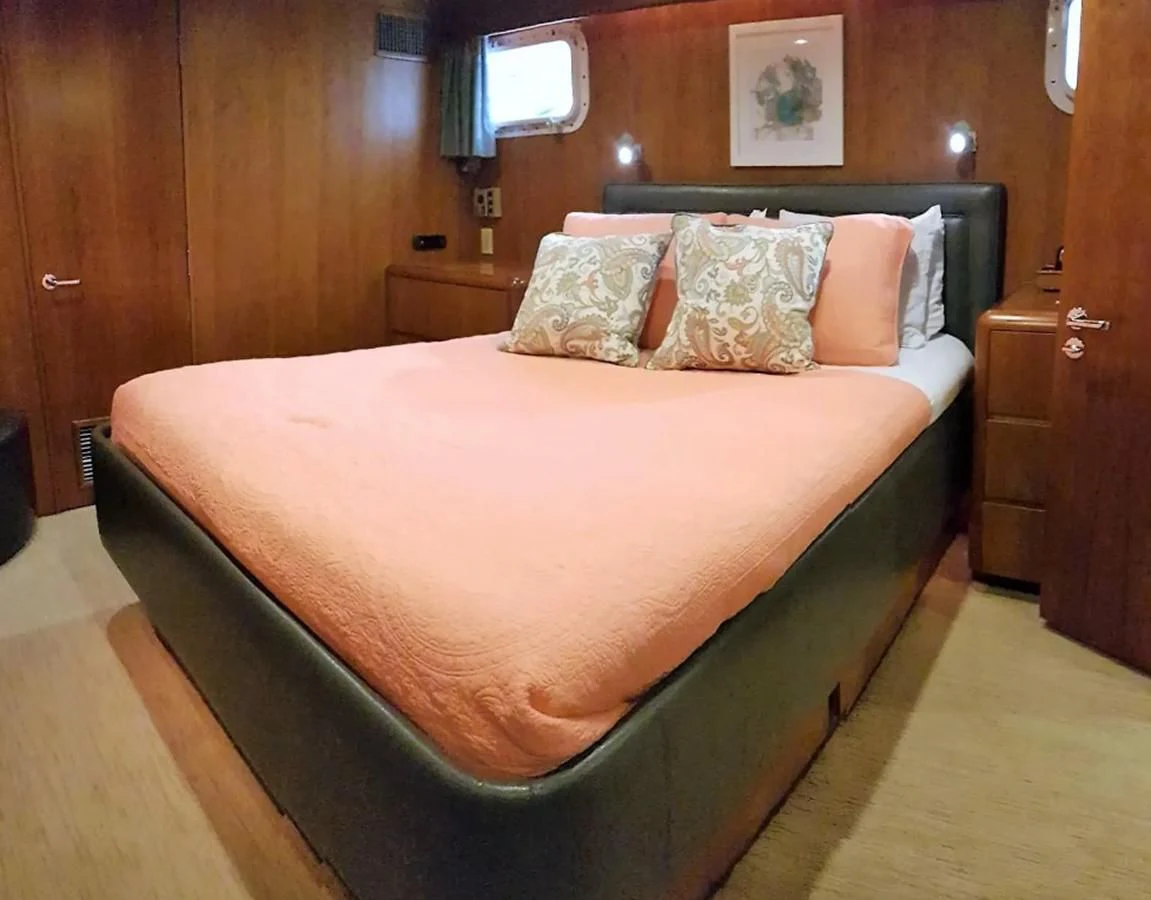a bed with a white comforter aboard GOLDEN EAGLE Yacht for Sale