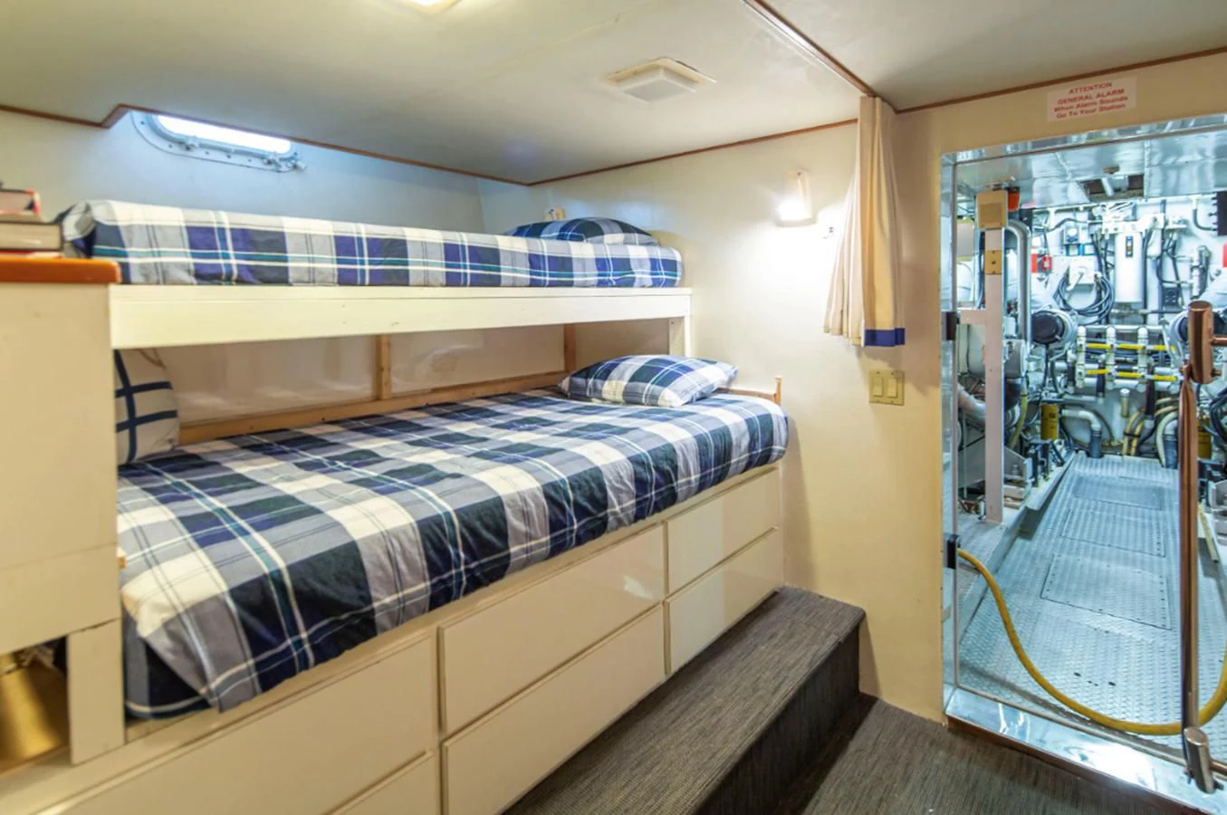 a bedroom with a bed and a blue and white striped bed aboard GOLDEN EAGLE Yacht for Sale