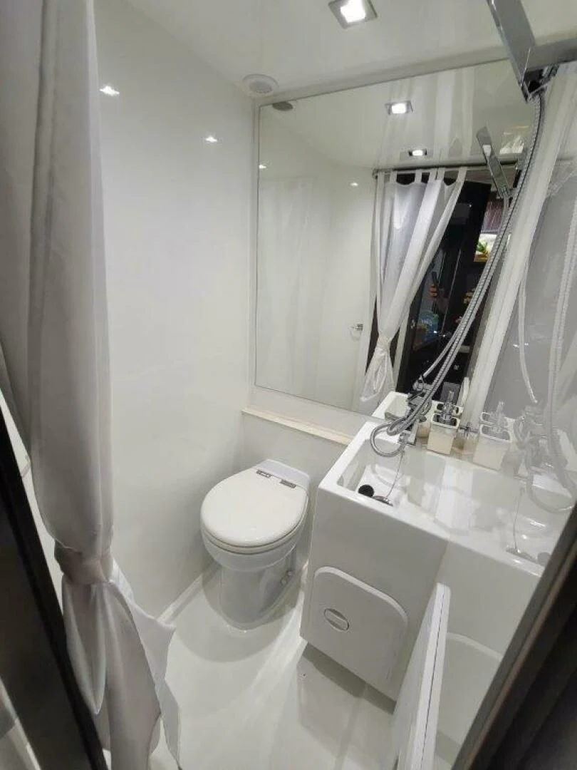 a bathroom with a toilet sink and a mirror aboard GODSPEED Yacht for Sale