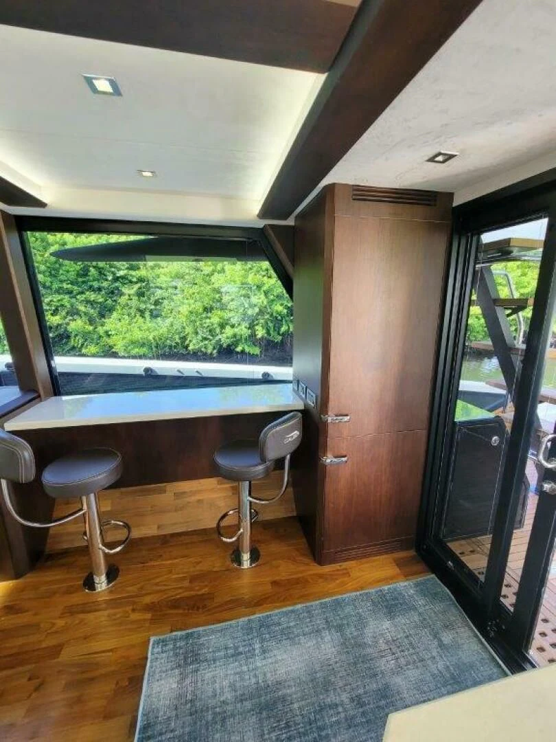 a room with a chair and a table and a window aboard GODSPEED Yacht for Sale