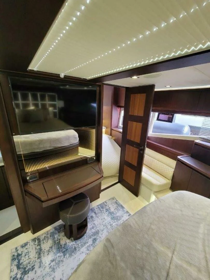 a room with a bed and a television aboard GODSPEED Yacht for Sale
