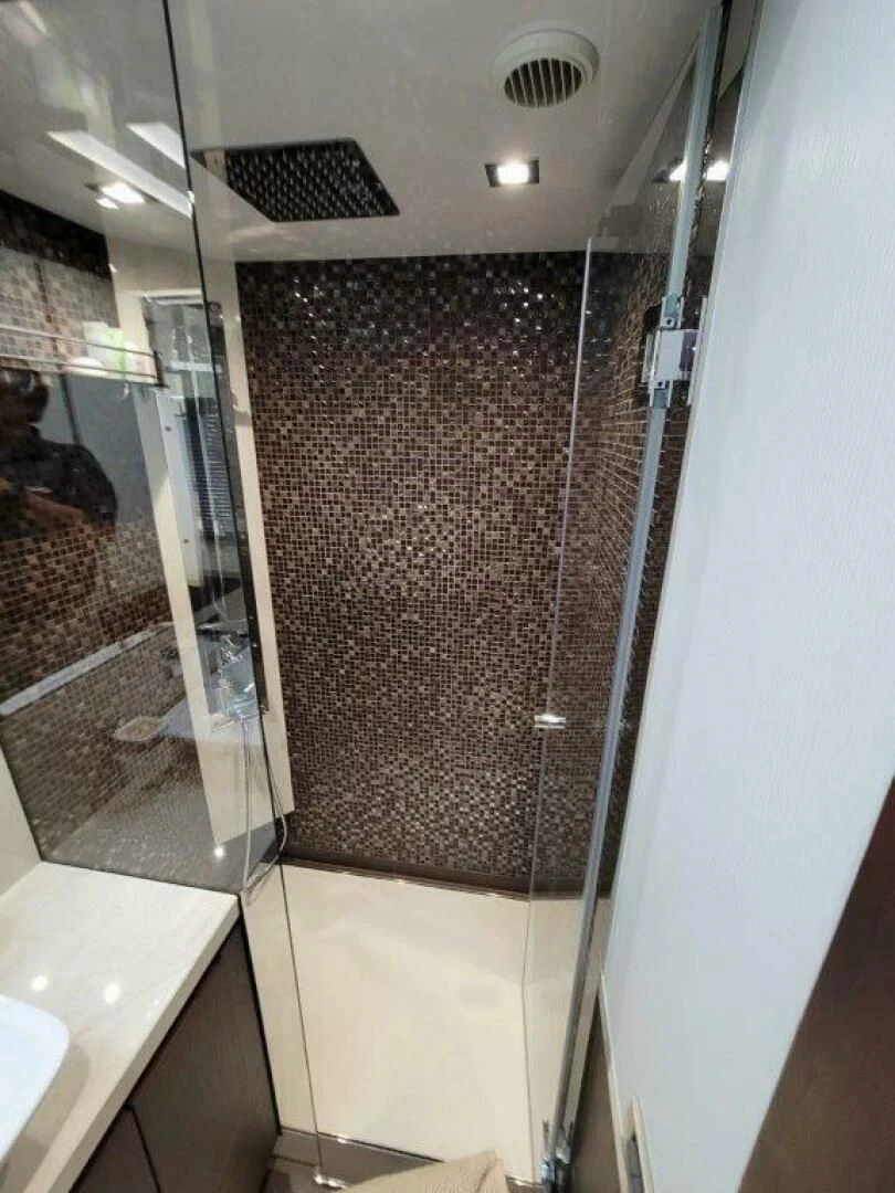 a shower unit with a tile floor aboard GODSPEED Yacht for Sale