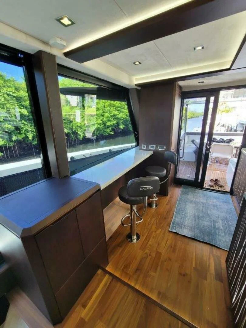 a room with a table and chairs aboard GODSPEED Yacht for Sale