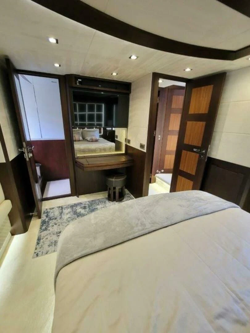 a bedroom with a bed and desk aboard GODSPEED Yacht for Sale