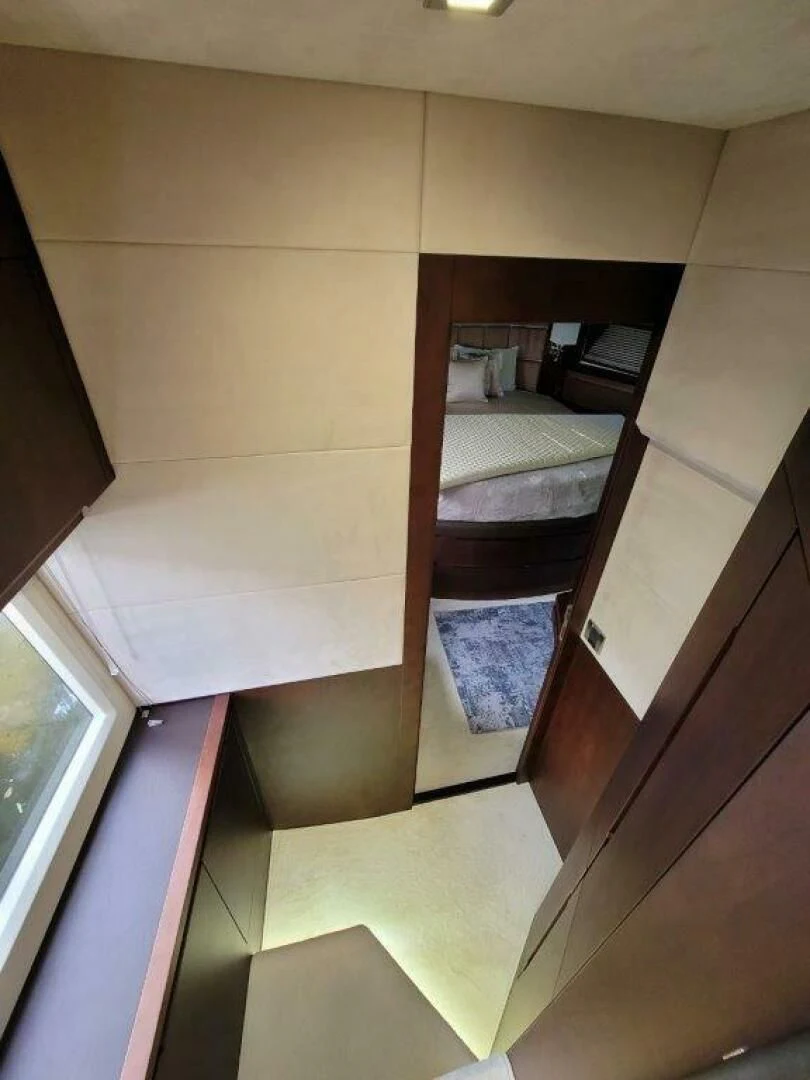 a room with a bed and a mirror aboard GODSPEED Yacht for Sale