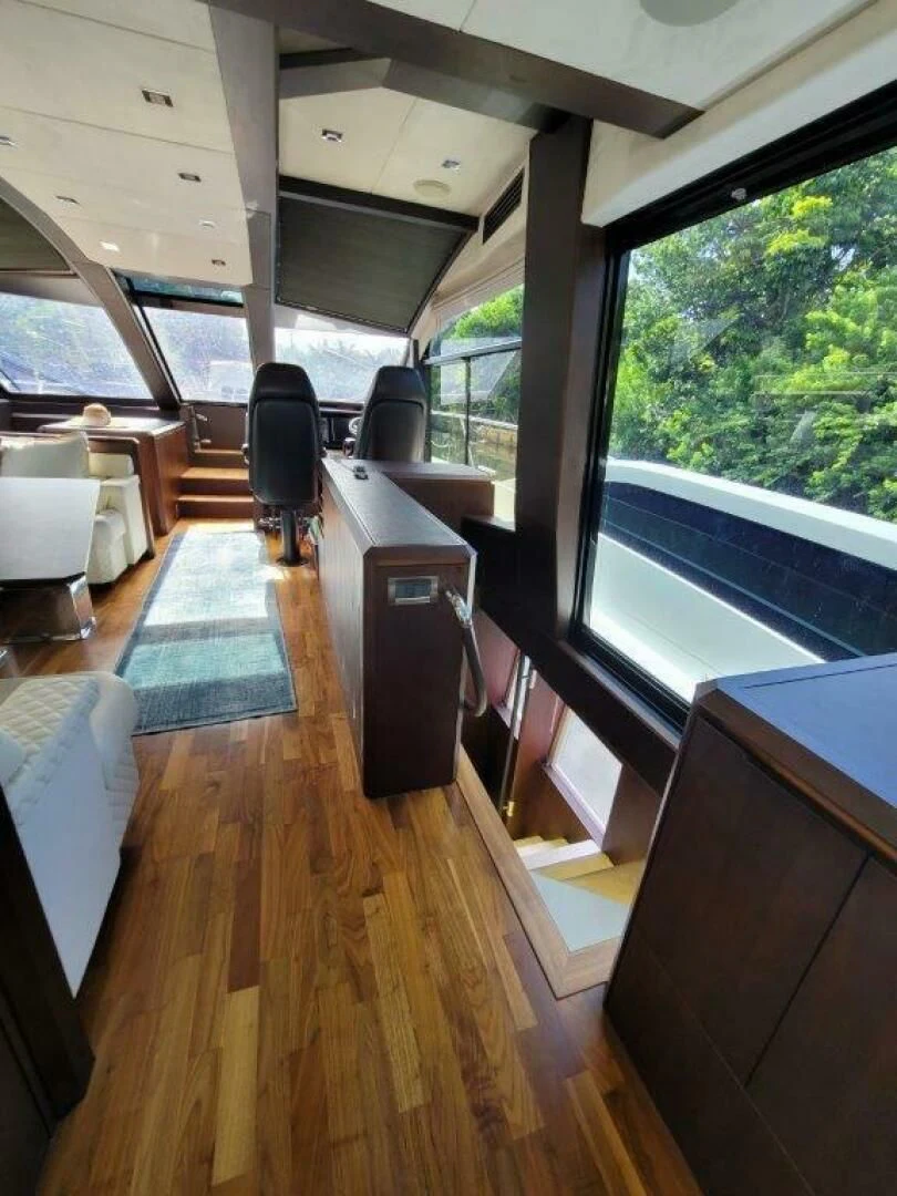 a room with a wood floor and a wood floor and a large window aboard GODSPEED Yacht for Sale