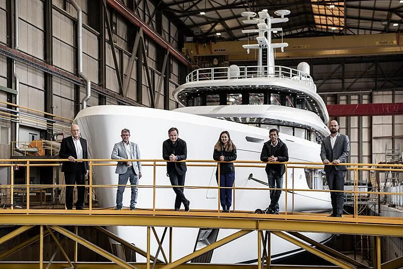 a group of people standing in front of a large white ship aboard ENERGY Yacht for Sale
