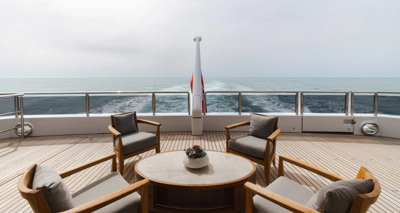 a table and chairs on a deck overlooking the ocean aboard ENERGY Yacht for Sale