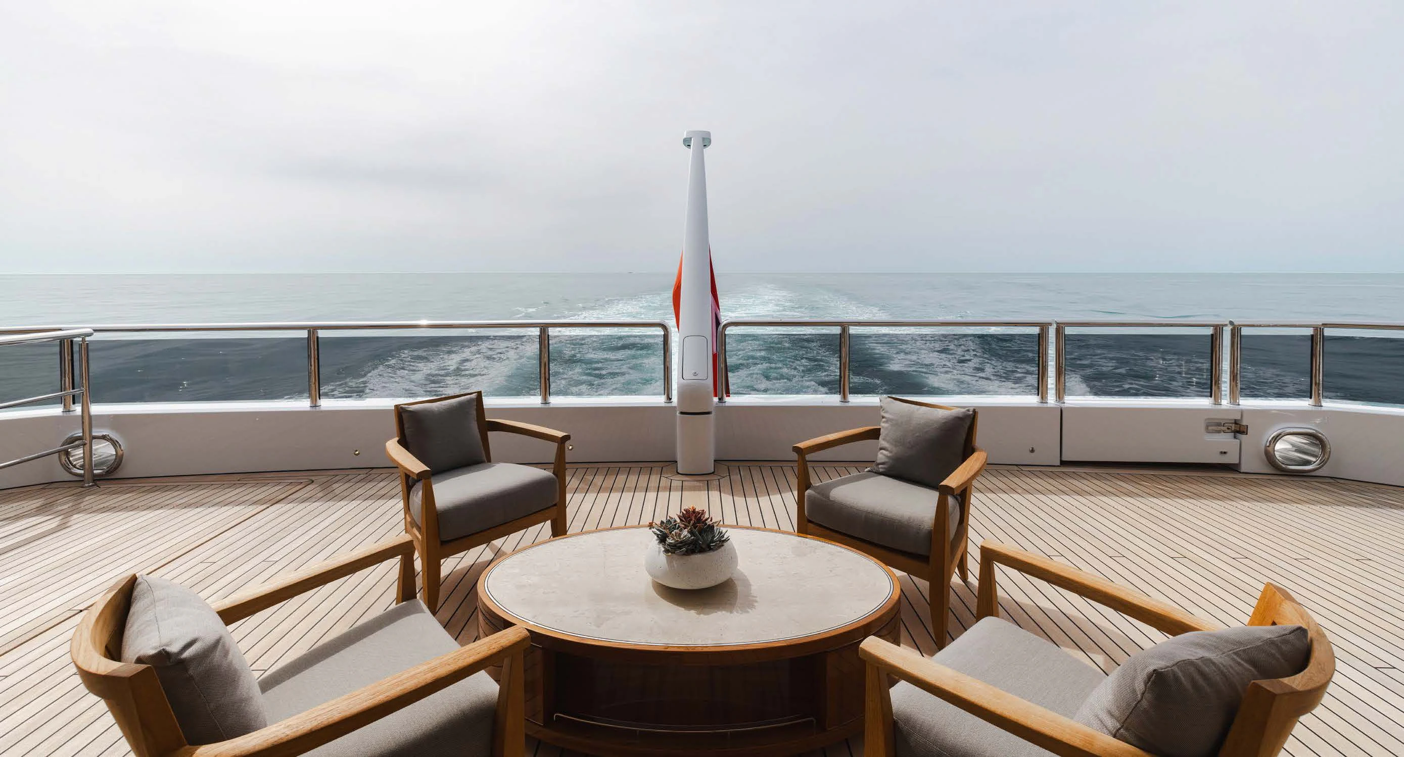 a table and chairs on a deck overlooking a body of water aboard ENERGY Yacht for Sale