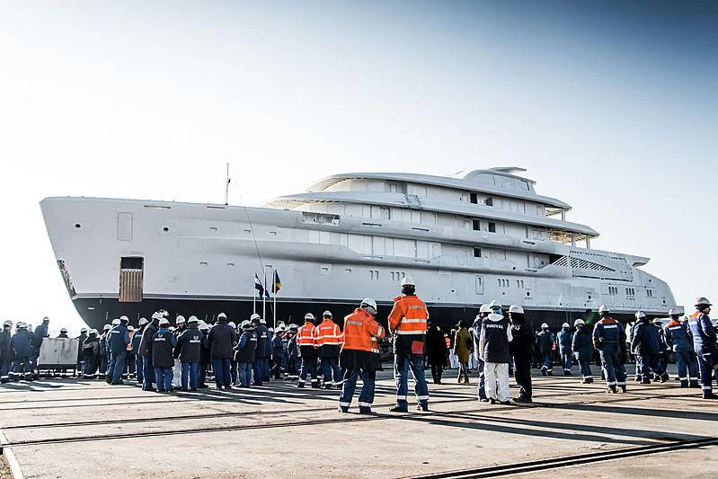 a group of people standing in front of a military jet aboard ENERGY Yacht for Sale