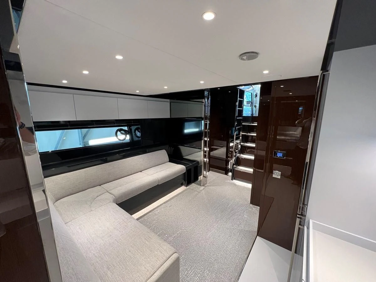a room with a couch and a tv aboard RIVA 68' DIABLE Yacht for Sale