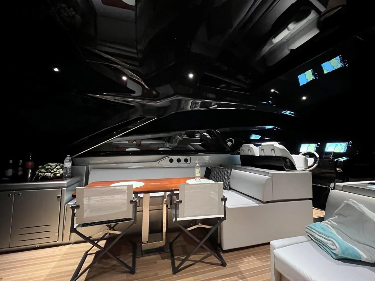 a room with a couch and a table and chairs aboard RIVA 68' DIABLE Yacht for Sale