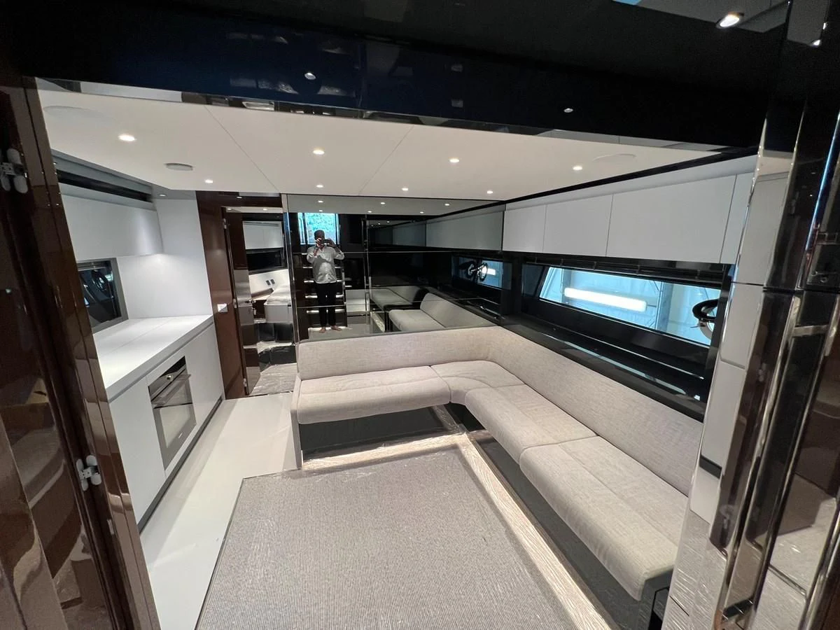 a room with a couch and a tv aboard RIVA 68' DIABLE Yacht for Sale