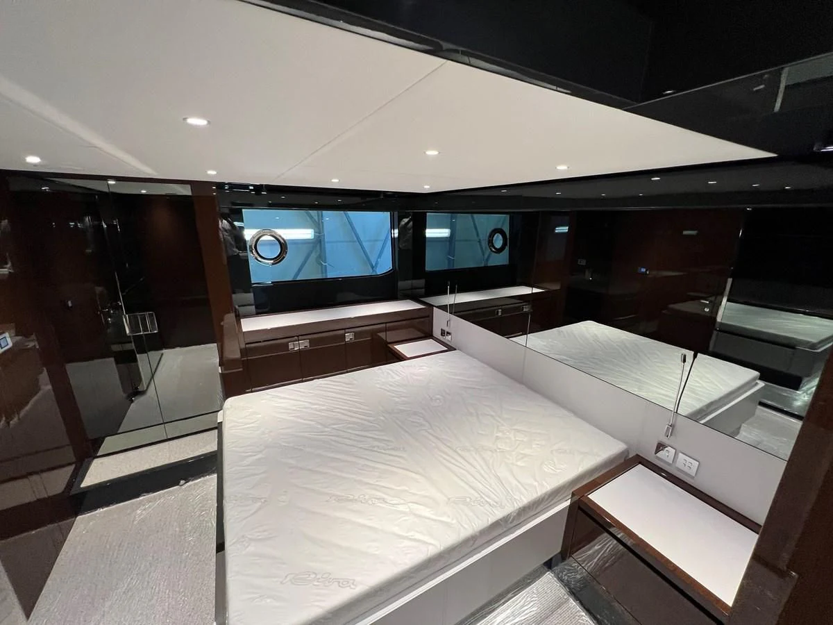 a room with a large bed aboard RIVA 68' DIABLE Yacht for Sale