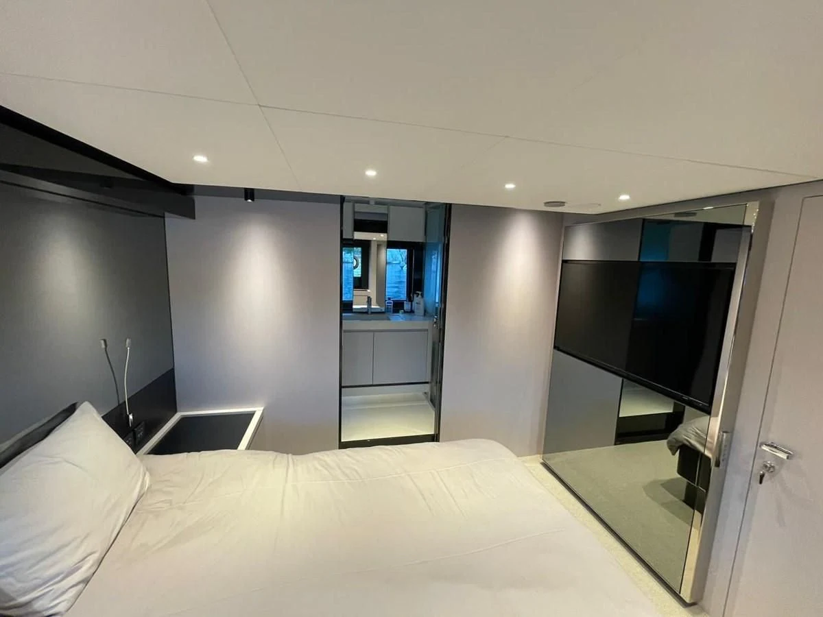 a bedroom with a bed and a desk aboard RIVA 68' DIABLE Yacht for Sale