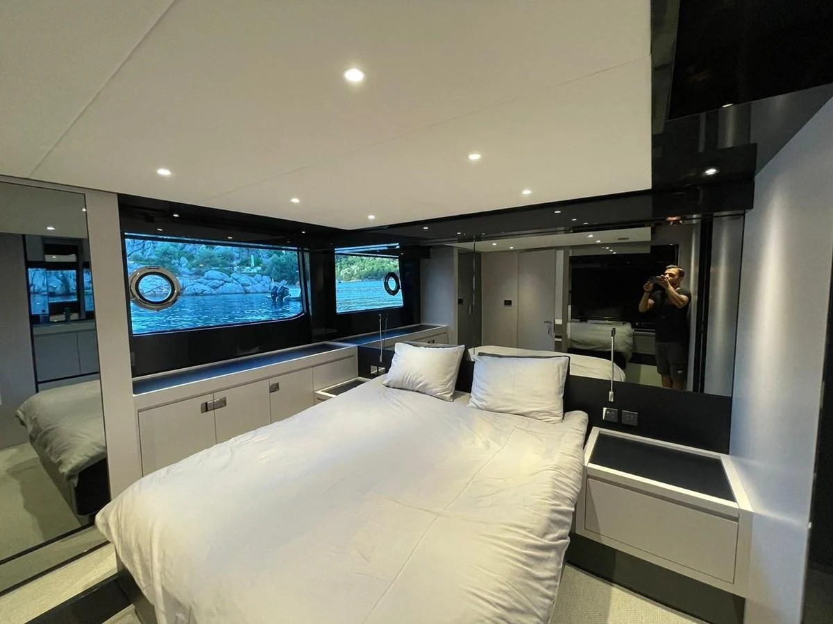 a room with a bed and a tv on the wall aboard RIVA 68' DIABLE Yacht for Sale