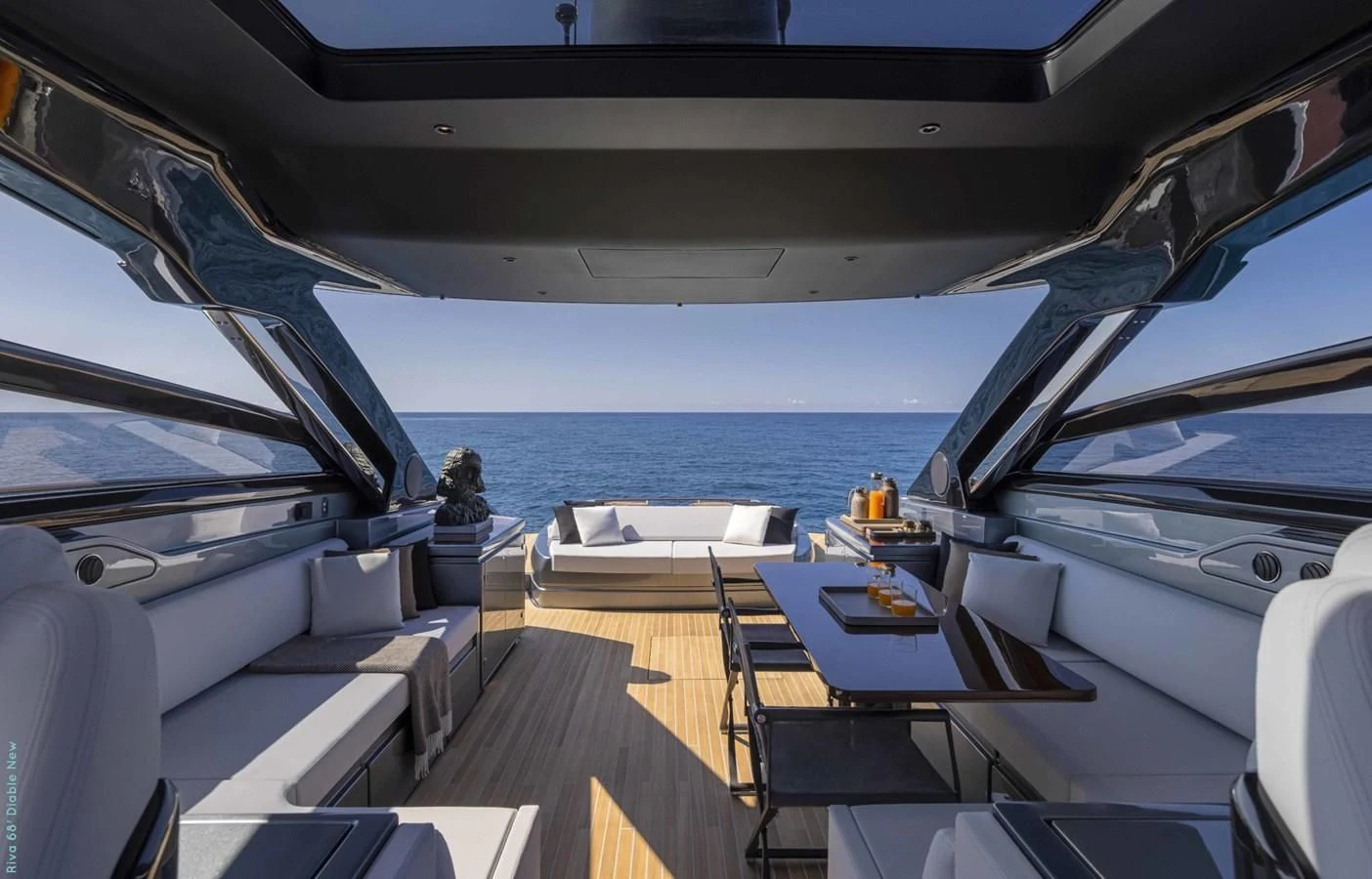 a boat with a table and chairs on it aboard RIVA 68' DIABLE Yacht for Sale