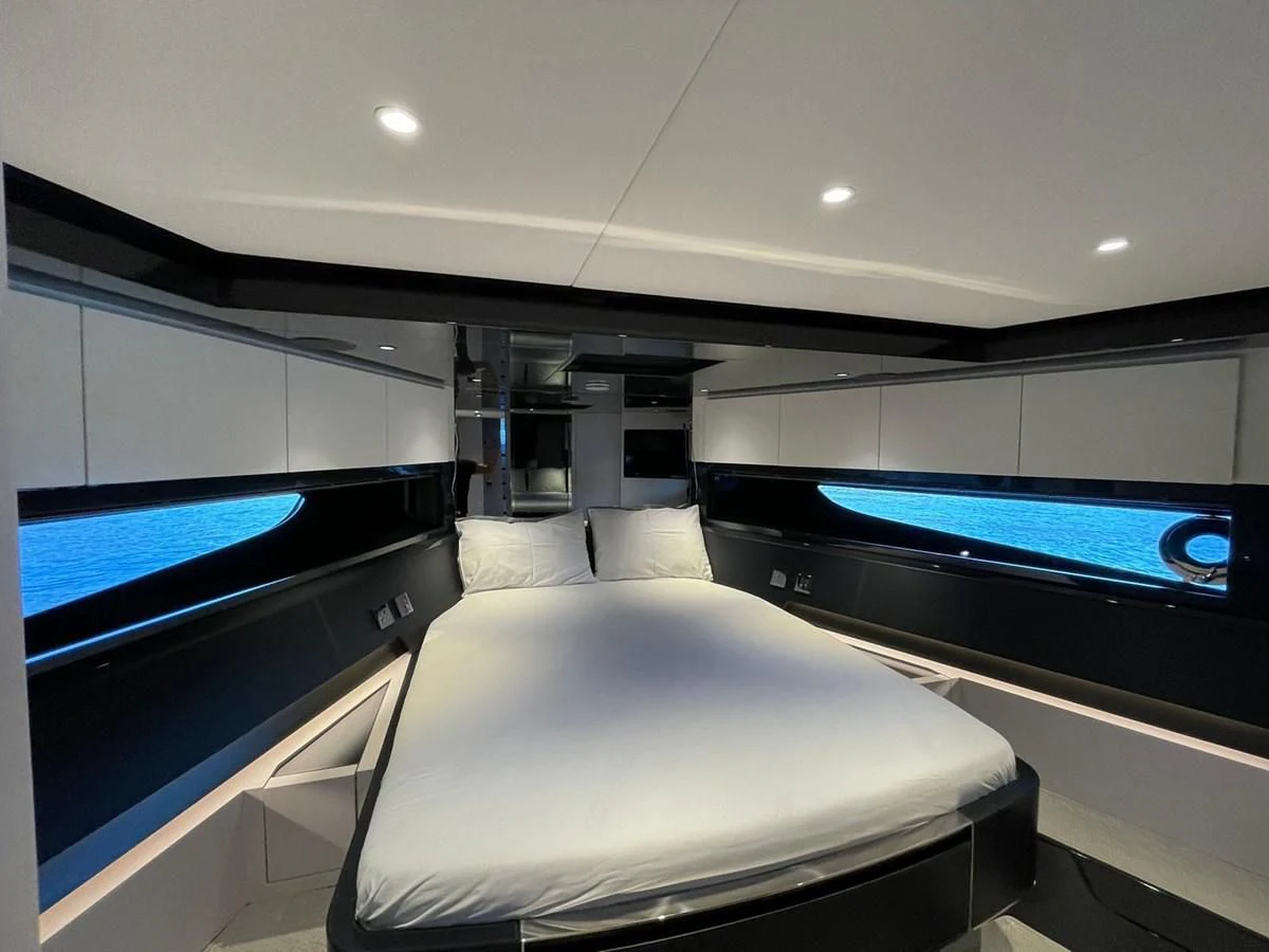 a room with a bed and a tv on the wall aboard RIVA 68' DIABLE Yacht for Sale