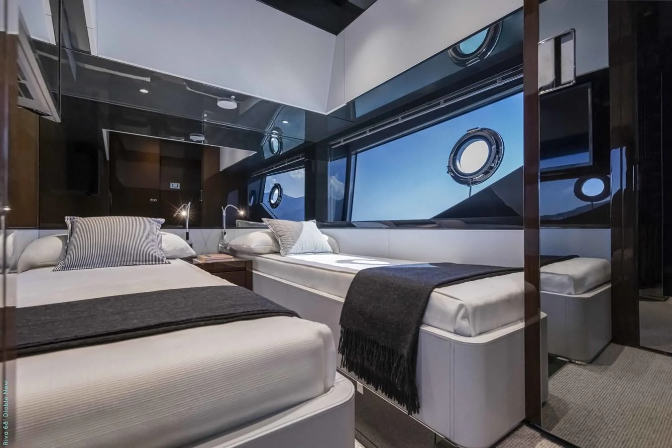 a room with beds and a large screen aboard RIVA 68' DIABLE Yacht for Sale