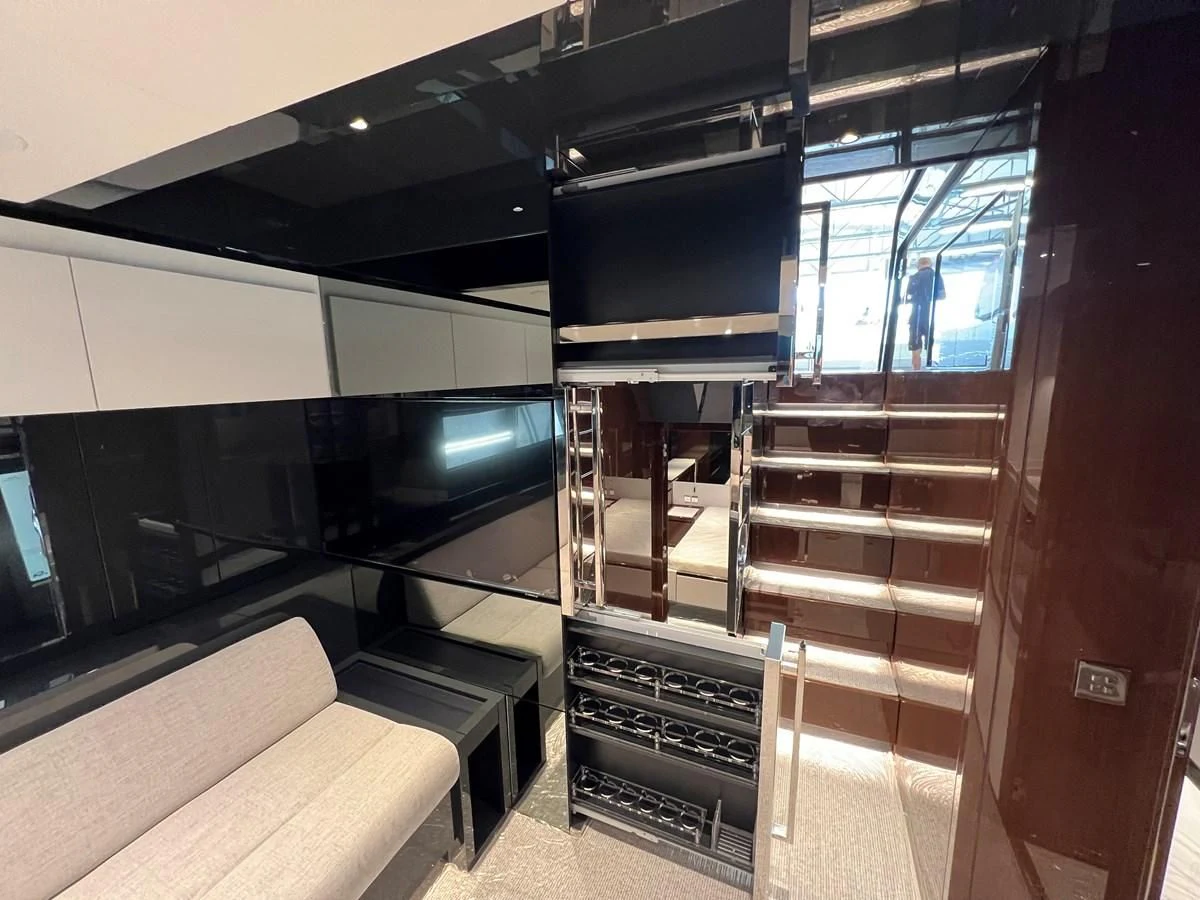 a room with a couch and a tv aboard RIVA 68' DIABLE Yacht for Sale