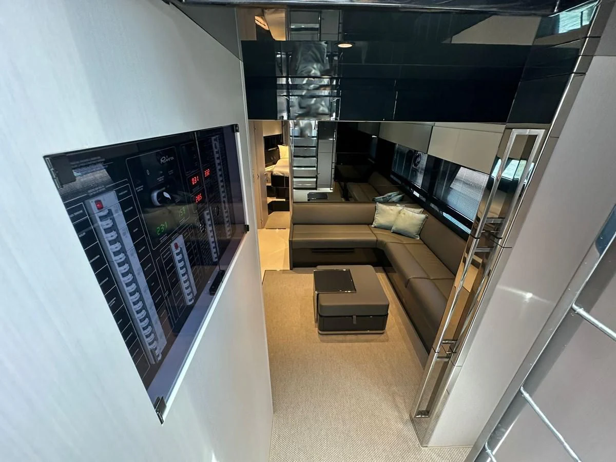 a room with a couch and a table aboard RIVA 68' DIABLE Yacht for Sale