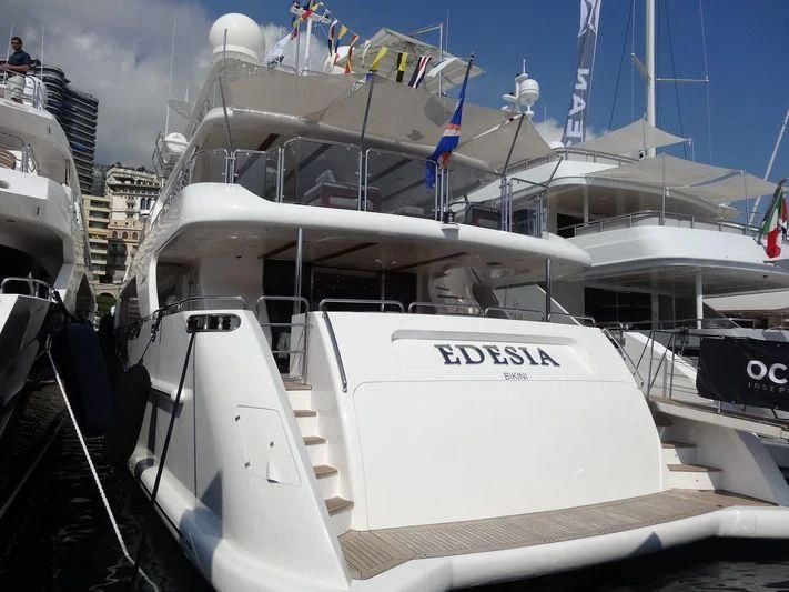 a white boat with a blue crane on it aboard EDESIA Yacht for Sale