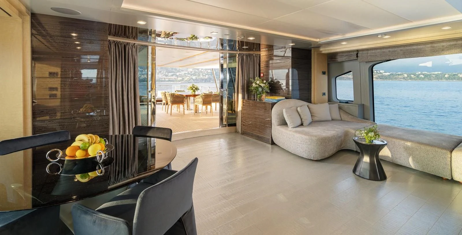 a living room with a glass table aboard EDESIA Yacht for Sale