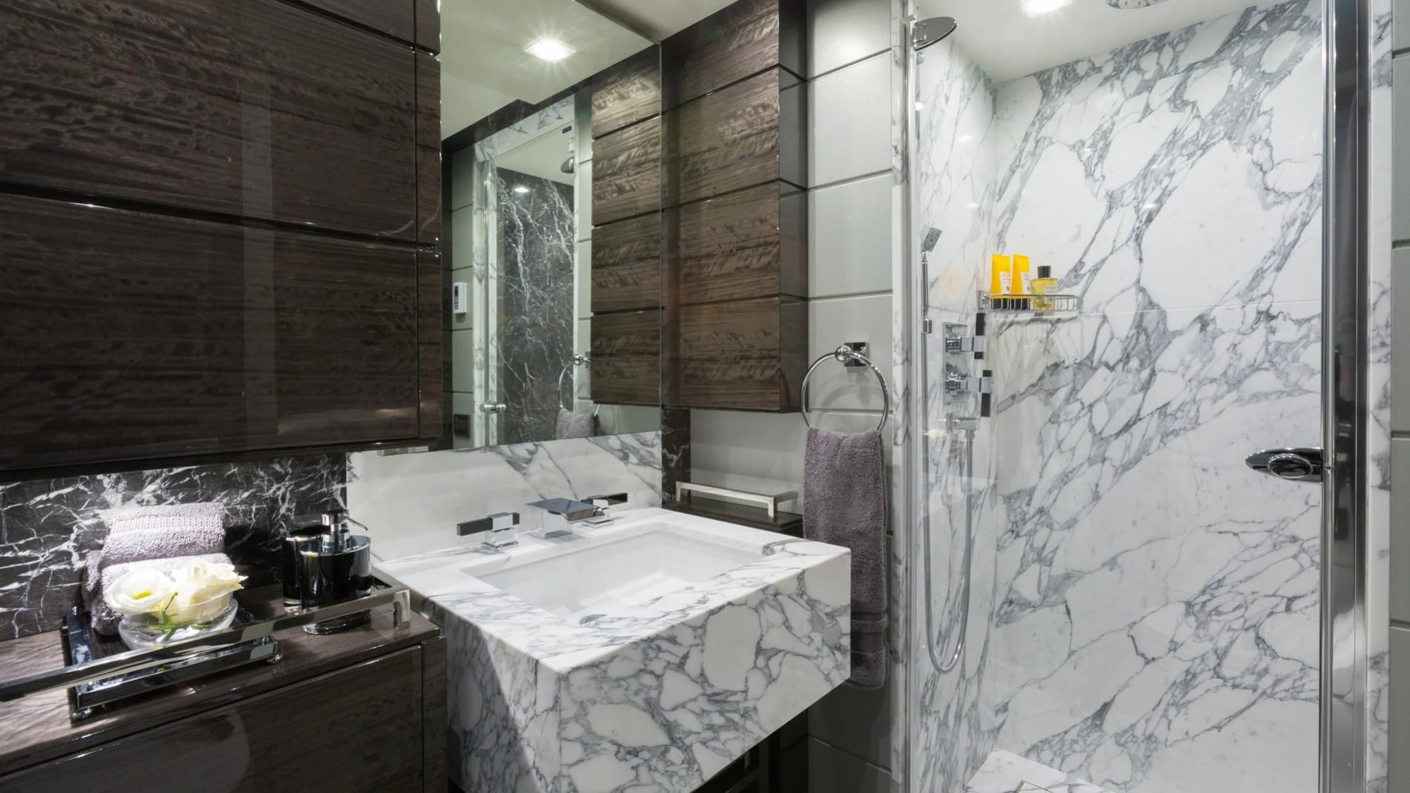 a bathroom with a sink and a large mirror aboard EDESIA Yacht for Sale