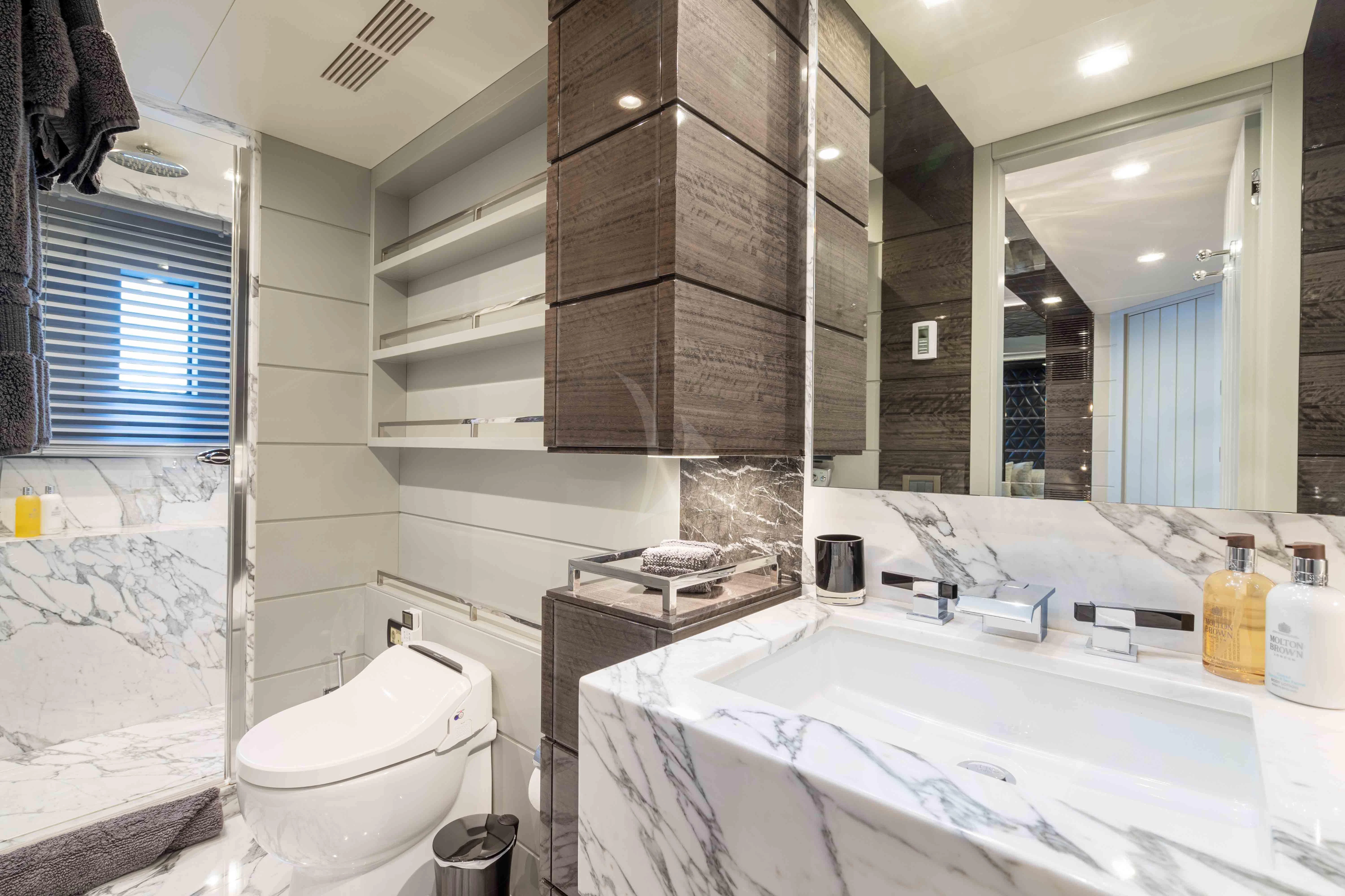 a bathroom with a toilet sink and a mirror aboard EDESIA Yacht for Sale