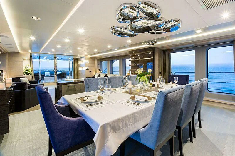 a large dining room with a large table and chairs aboard EDESIA Yacht for Sale
