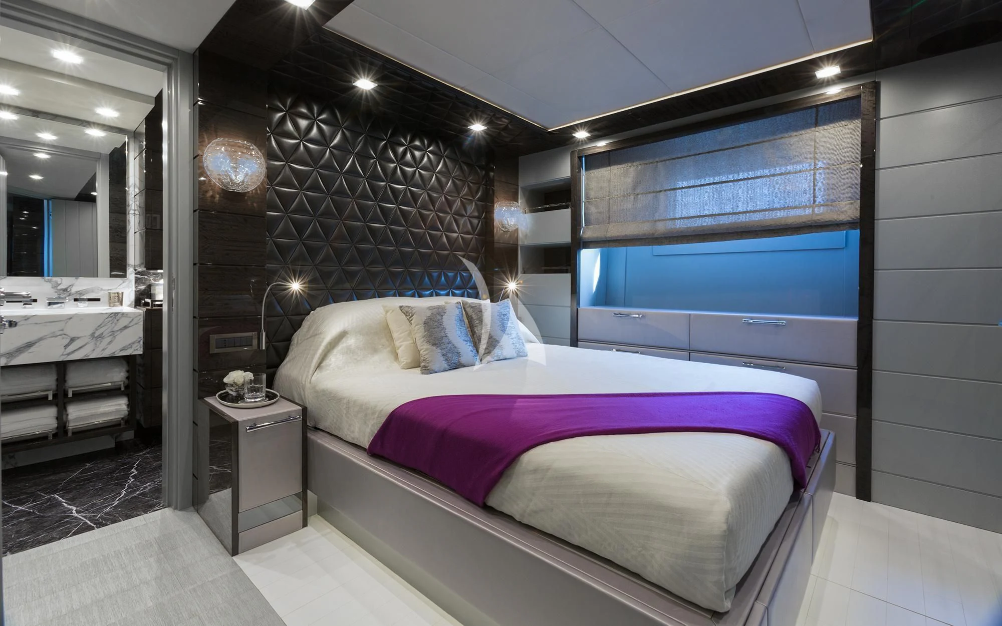 a bedroom with a bed and a window aboard EDESIA Yacht for Sale