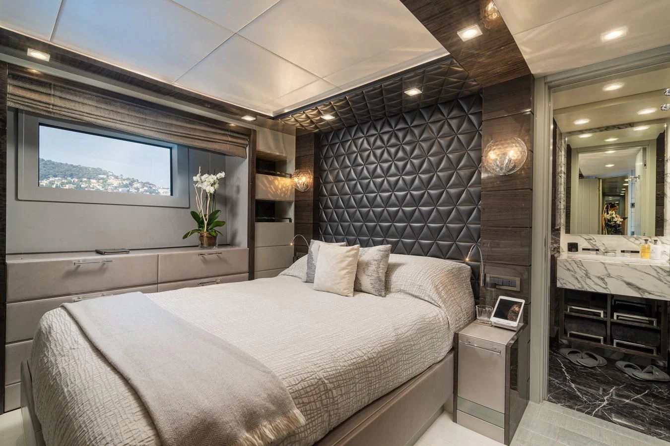 a bedroom with a bed and a television aboard EDESIA Yacht for Sale