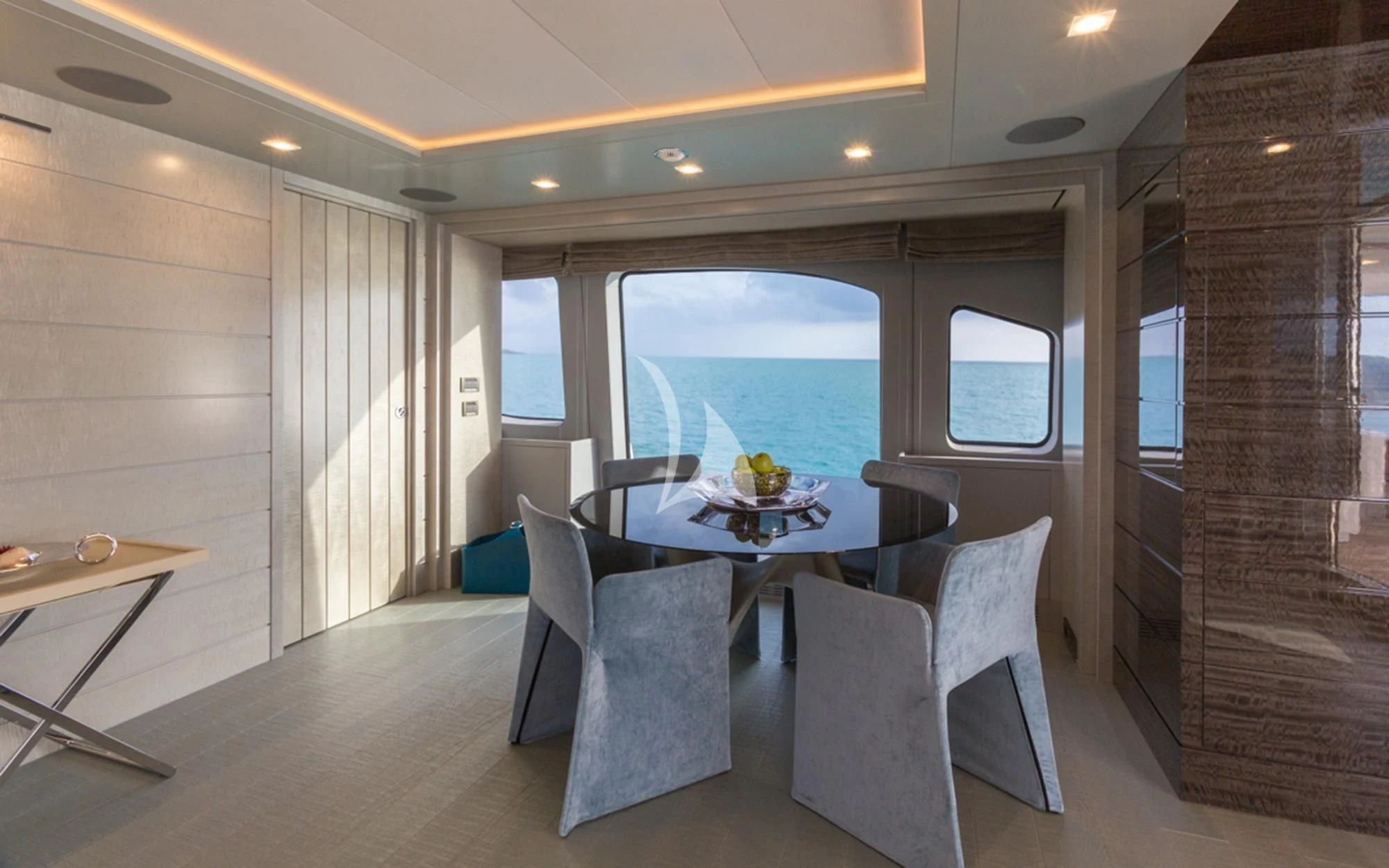 a room with a table chairs and a view of the ocean aboard EDESIA Yacht for Sale