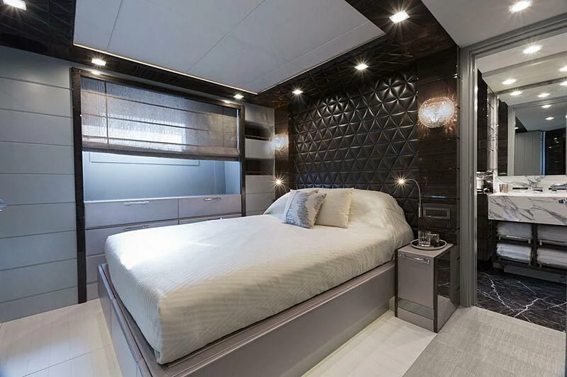 a large bedroom with a large mirror aboard EDESIA Yacht for Sale