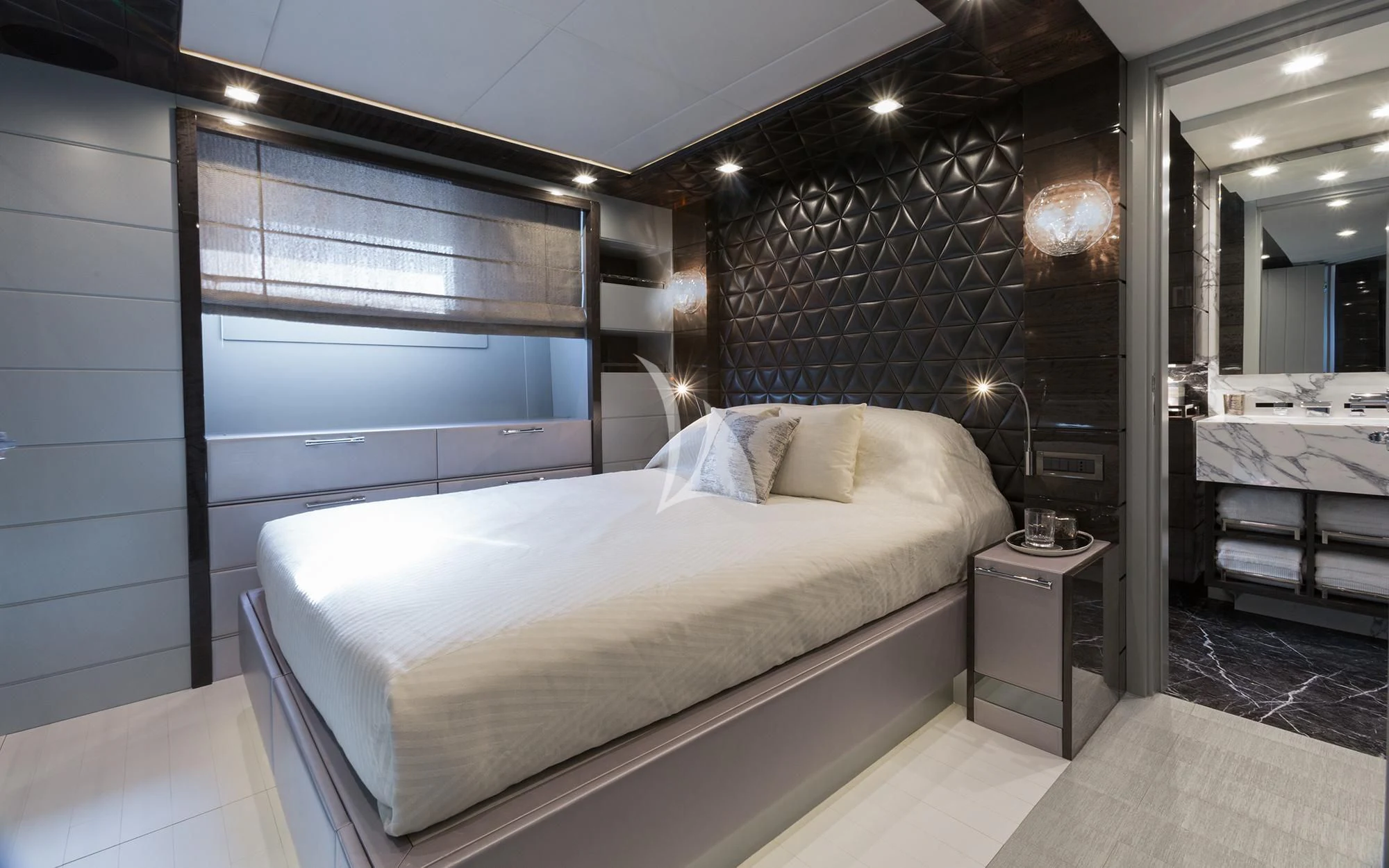 a bedroom with a bed and a mirror aboard EDESIA Yacht for Sale
