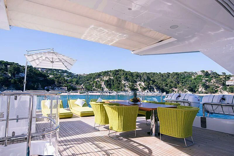 a deck with chairs and tables aboard EDESIA Yacht for Sale