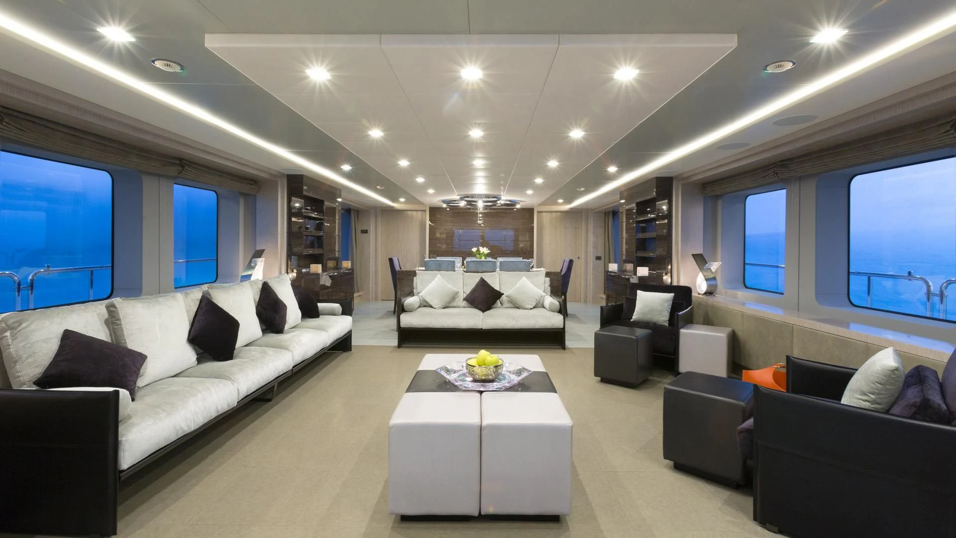 a living room with a large white couch and a large window aboard EDESIA Yacht for Sale