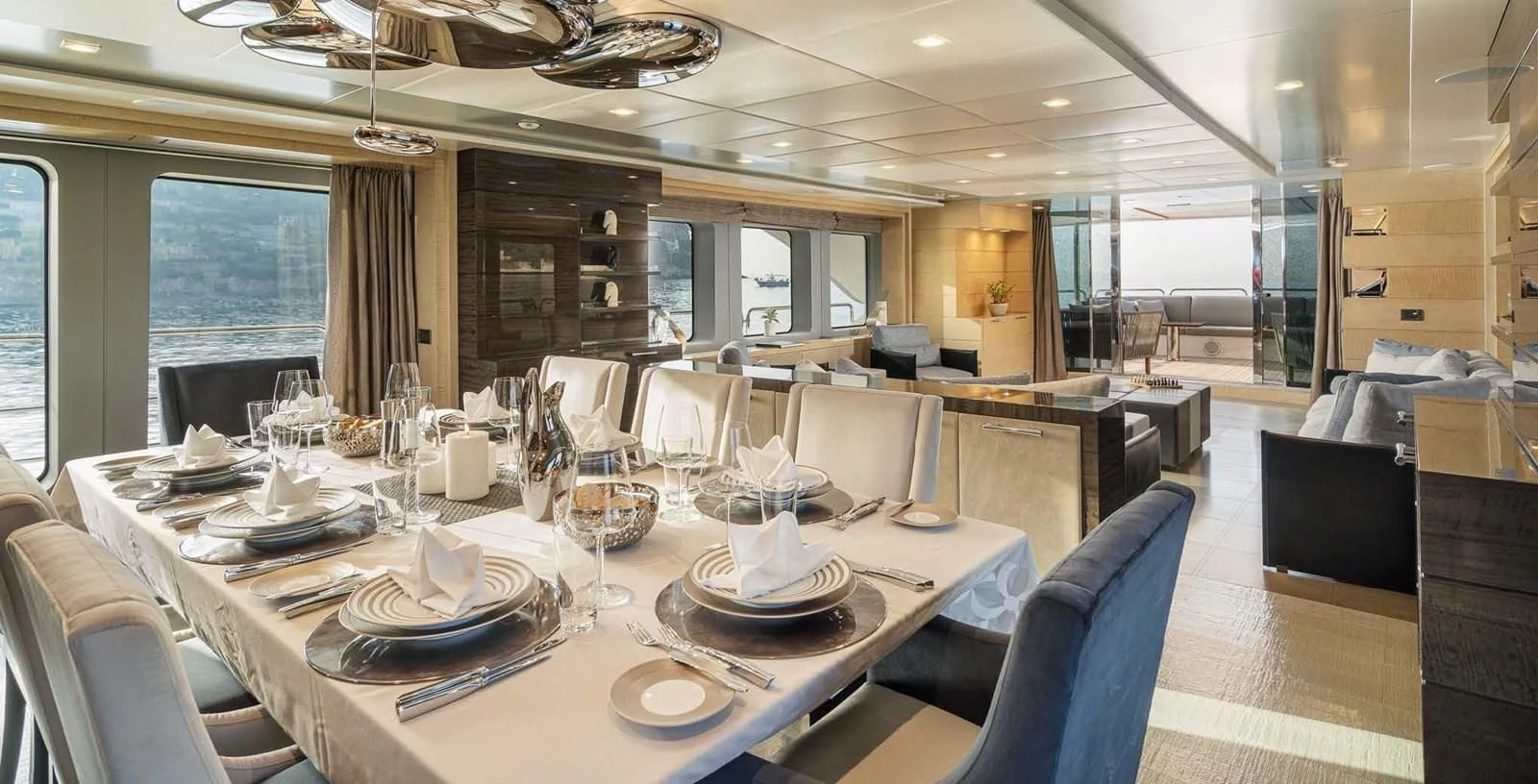 a large dining table with plates and glasses on it aboard EDESIA Yacht for Sale