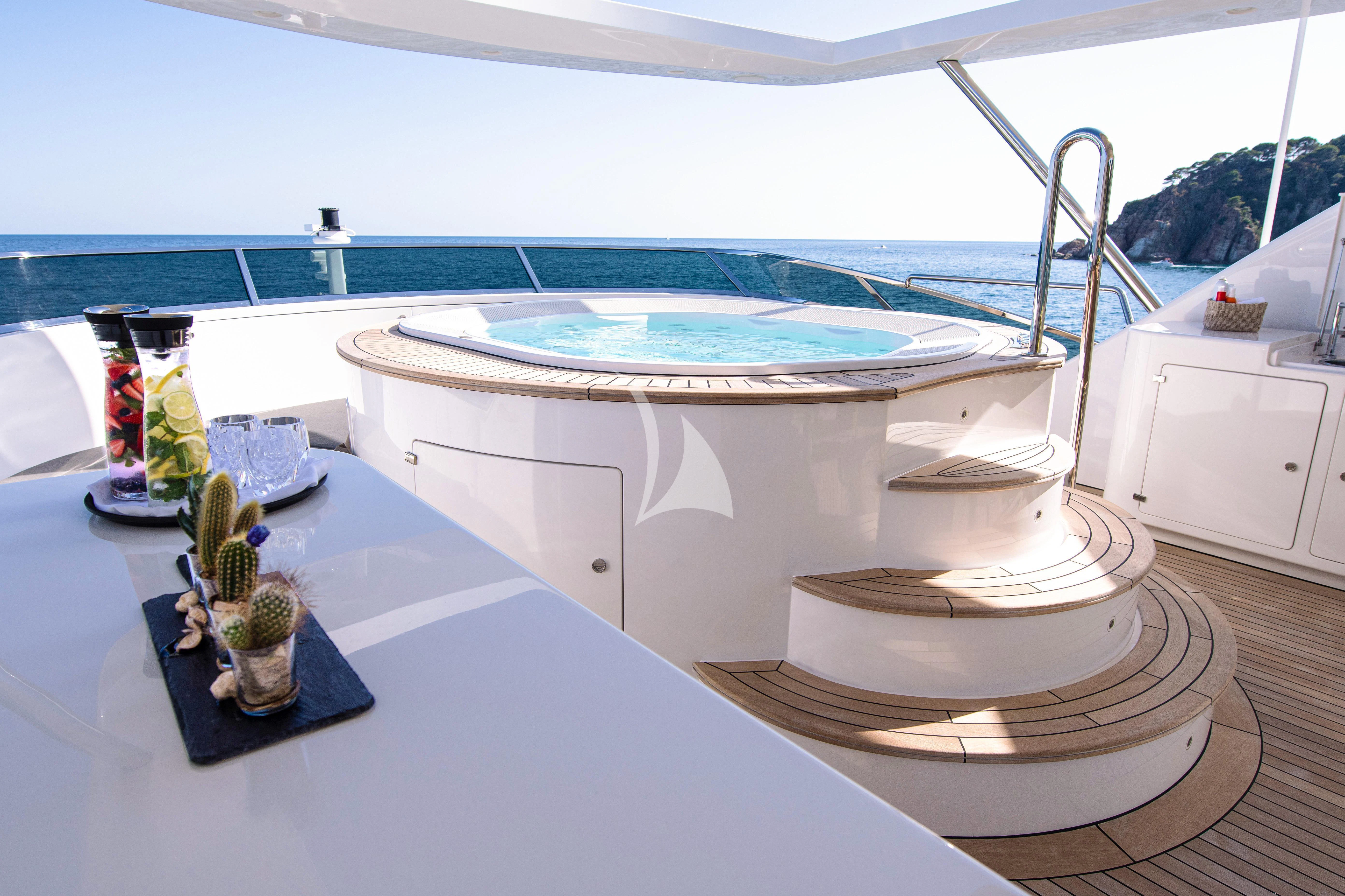 a table with a pool and a table with food on it aboard EDESIA Yacht for Sale