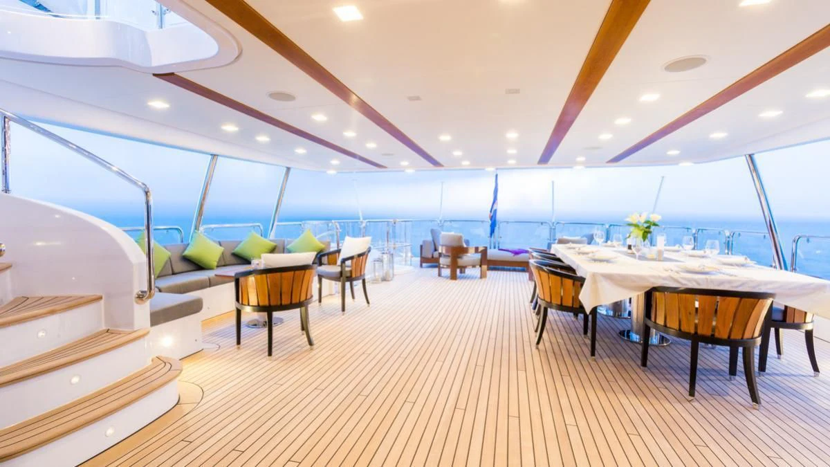 a room with tables and chairs aboard EDESIA Yacht for Sale