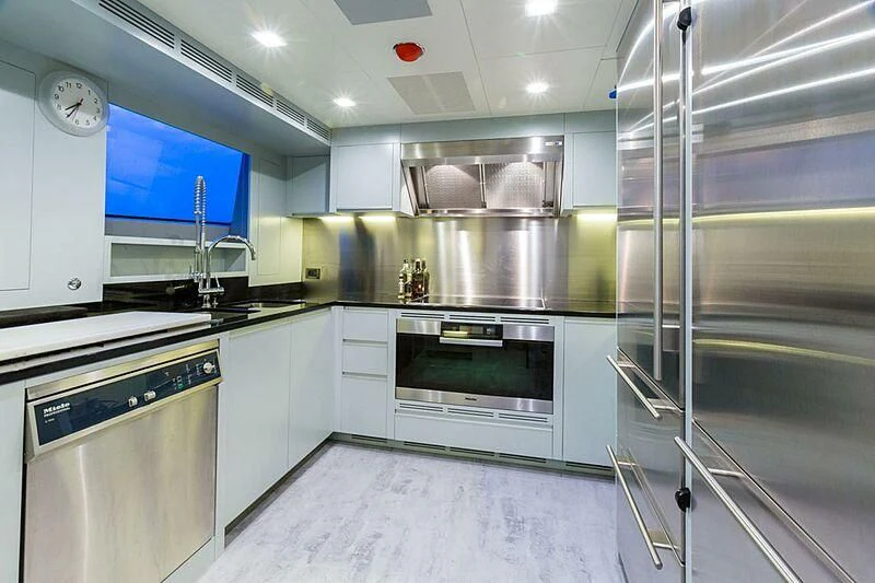 a kitchen with stainless steel appliances aboard EDESIA Yacht for Sale