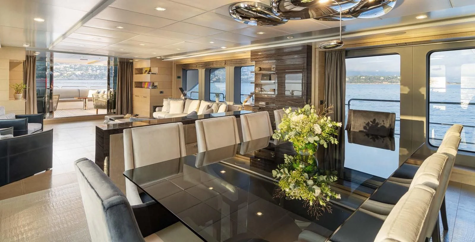 a large room with a large window and a large sofa aboard EDESIA Yacht for Sale