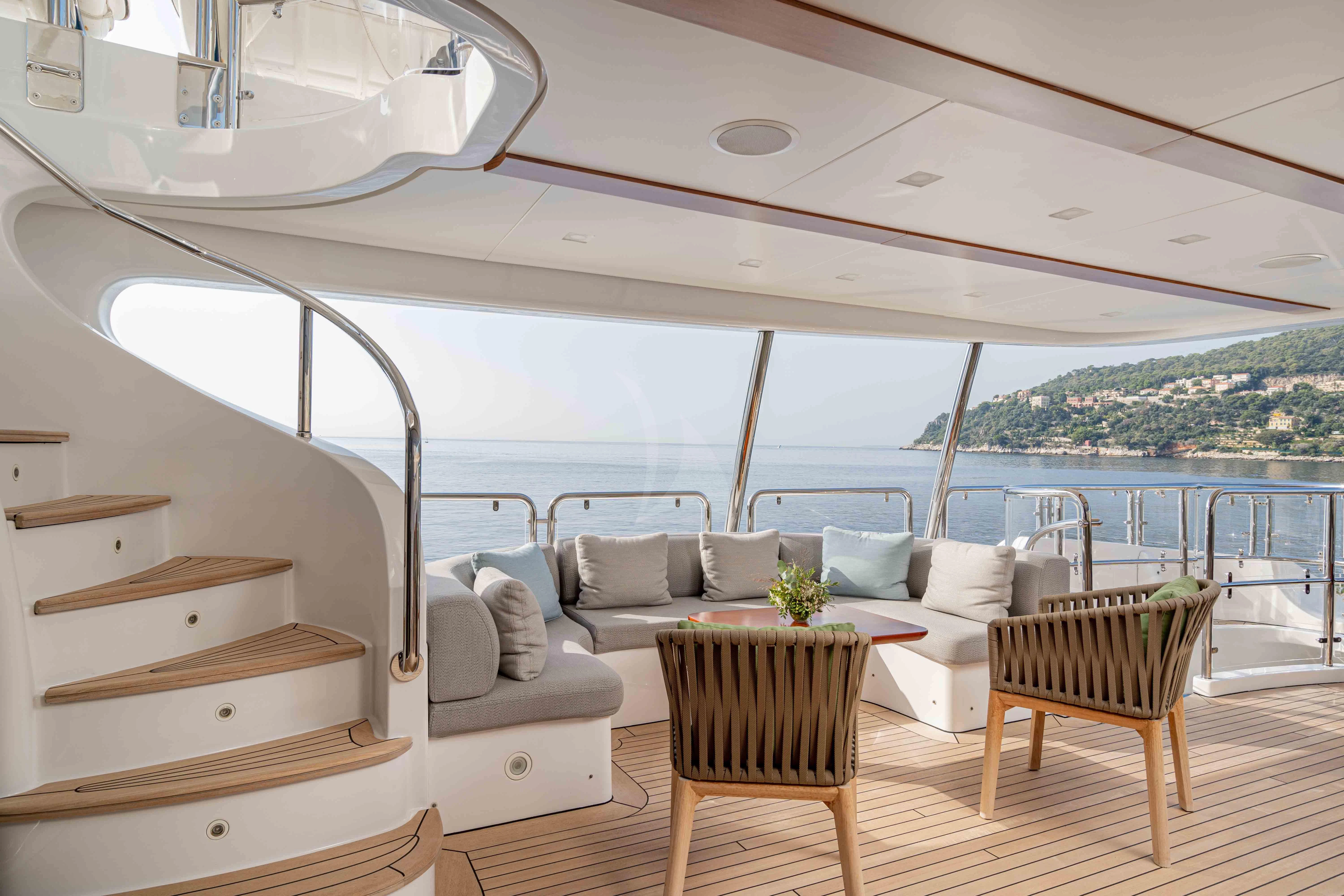 a room with a couch and a table and a large window aboard EDESIA Yacht for Sale