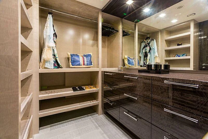 a room with a shelf and a shelf with clothes on it aboard EDESIA Yacht for Sale